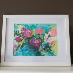 A white framed acrylic floral painting of a pink rose bouquet against an abstract teal and yellow background.